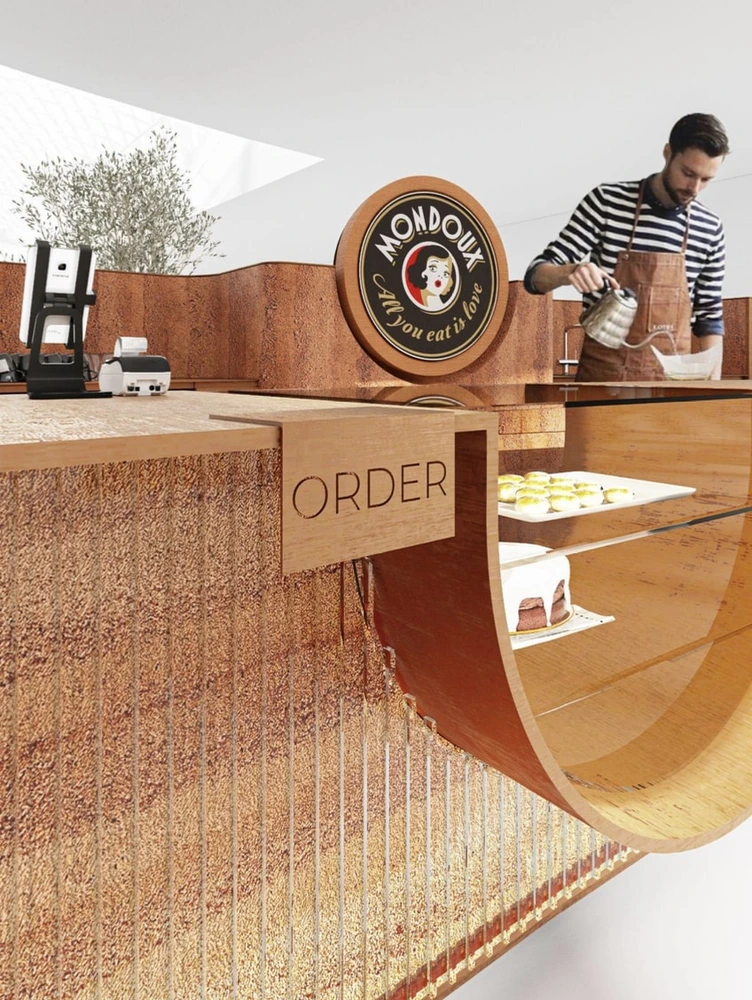 Barista behind the counter at the Mondieu Specialty Coffee kiosk in Eurovea