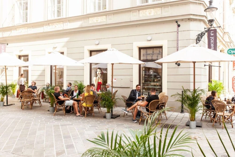 Guests dining on the terrace at Mondieu Franchise No. 1 in Bratislava