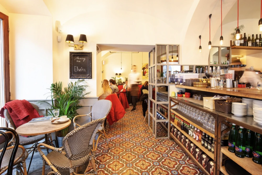 Colourful tiled interior and product shelves at Mondieu Panská 27